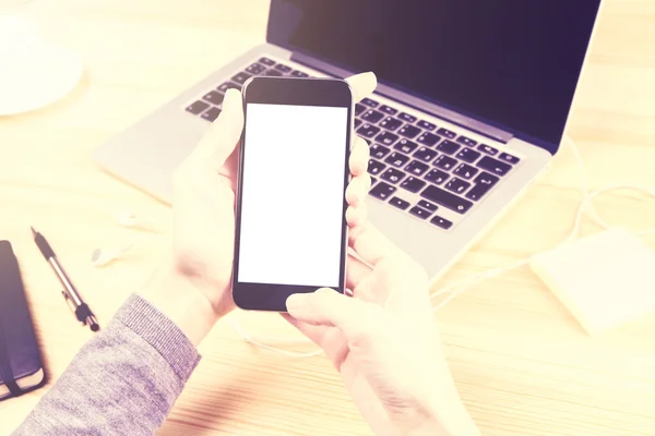 Chica con teléfono inteligente en blanco y portátil — Foto de Stock