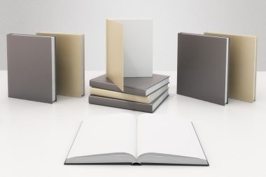 Blank book pages on white table with other books with blank cove clipart