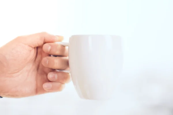 Hand gripping cup — Stock Photo, Image