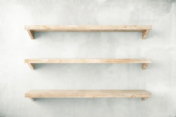 Empty shelves on concrete wall — Stock Photo, Image