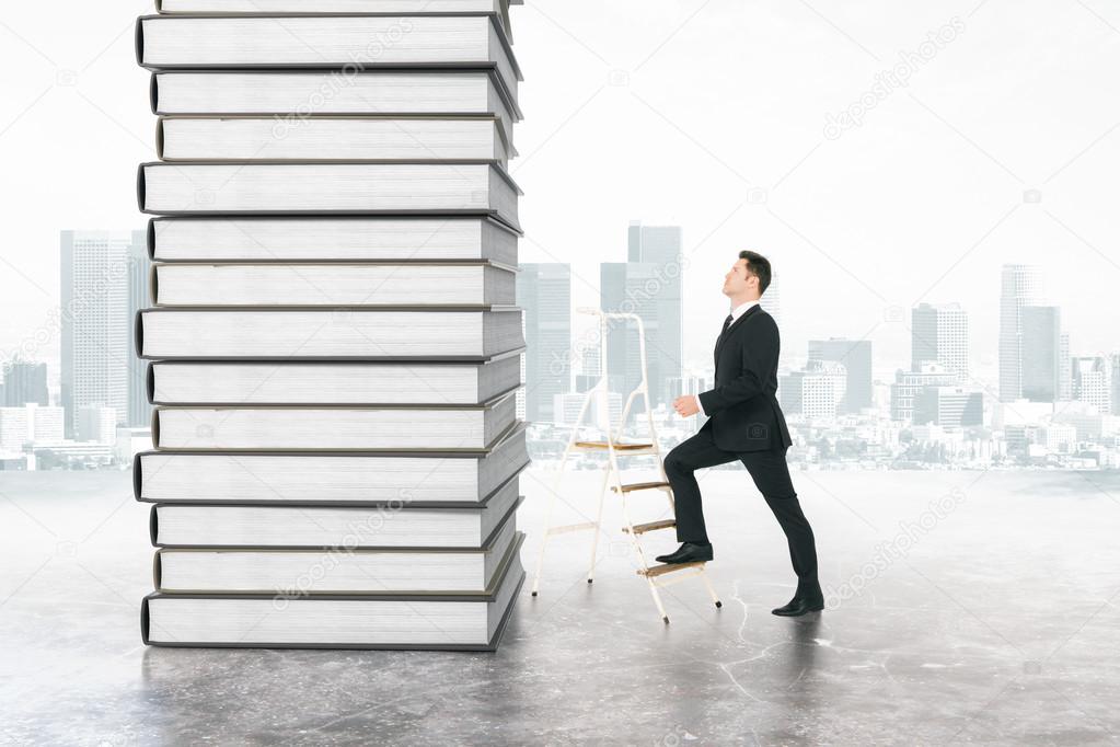 businessman climbing on books stack