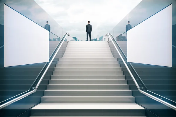 Businessman on white stairs — Stock Photo, Image