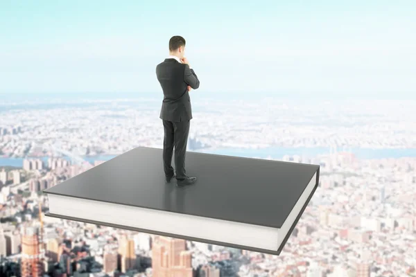 Businessman on black book — Stock Photo, Image