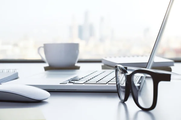 White desktop with items on city background — Stock Photo, Image