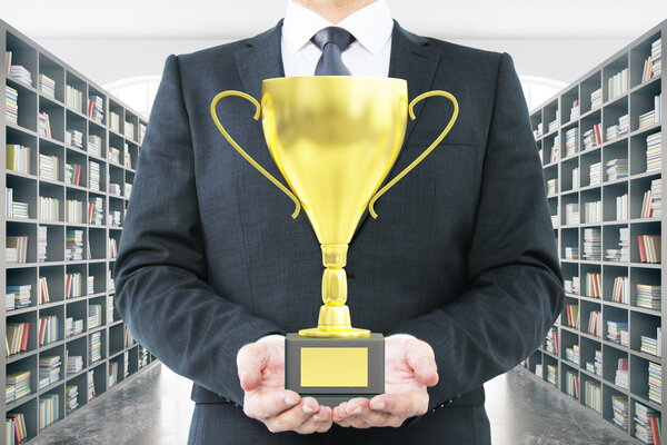 Man with trophy library background