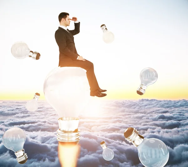 Businessperson on rocket lightbulb — Stock Photo, Image