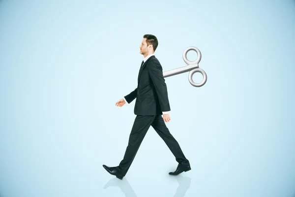 Walking man with wind-up key — Stock Photo, Image
