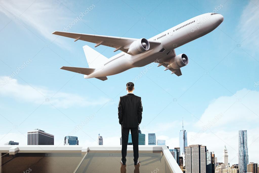 man looking at airplane 