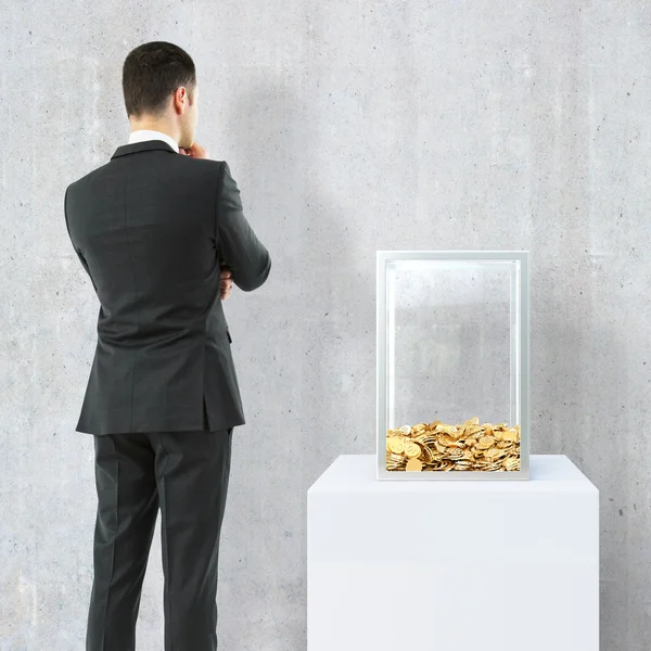 Businessman looking at donation box — Stock Photo, Image