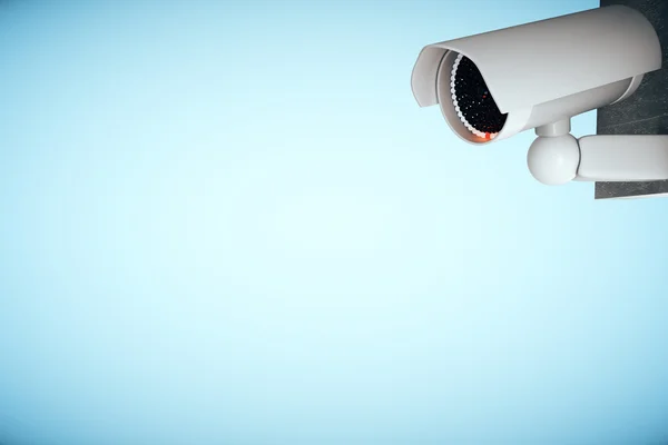 CCTV camera on blue background — Stock Photo, Image