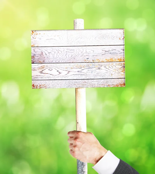 Männliche Hand mit Holzschild — Stockfoto