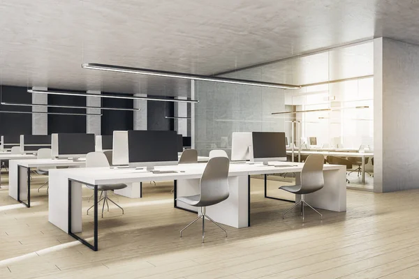 Coworking office in a loft style interior with computers and office chairs. Workplace and company concept. 3D Rendering