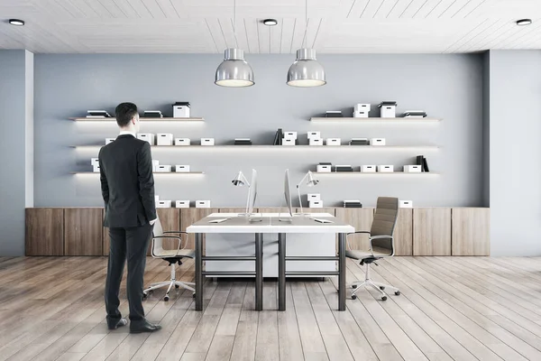 Businessman Standing Comfortable Office Interior Computers Table Chairs Shelf Box — Stock Photo, Image