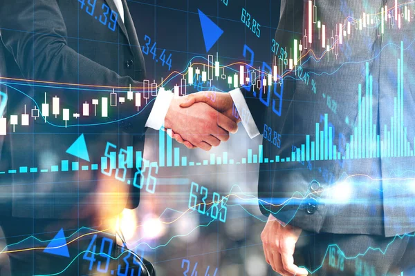 Business agreement concept with businessmen handshaking and digital financial chart screen with graphs and lines. Double exposure