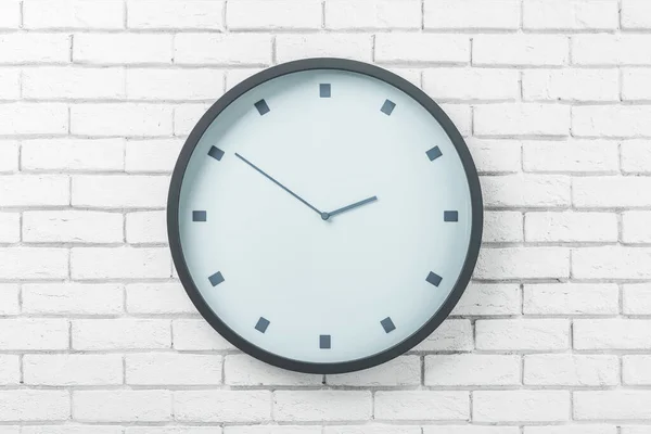 White round wall clock in black frame on light brick wall. 3D rendering