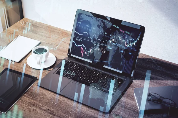 Stock market chart analysis on laptop display on wooden office table and abstract transparent screen with candlestick. Double exposure. 3D rendering