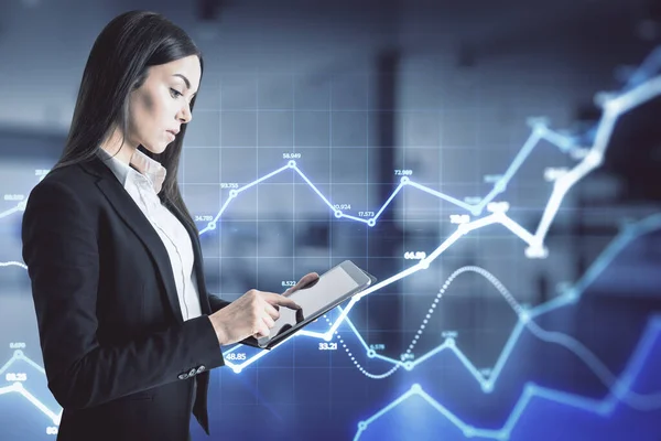 Big data analyzing and analytics concept with businesswoman and digital tablet on abstract background with glowing blue growing graphs. Double exposure