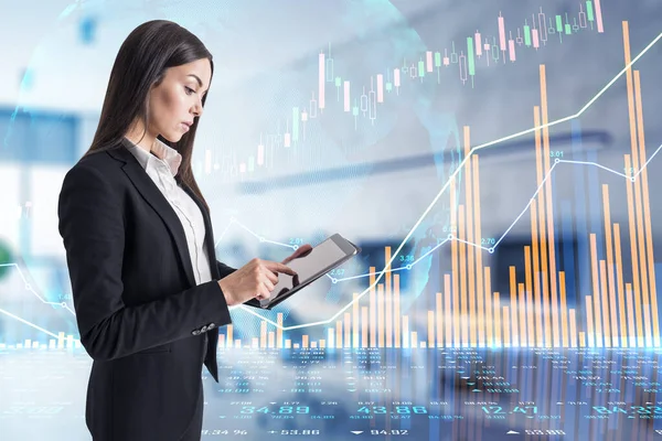 Analysis and analytics concept with digital tablet and businesswoman and growing financial graphs, candlestick and diagram on touch screen background. Double exposure