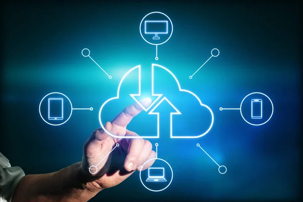 Internet and cloud concept with man finger on digital touch screen with cloud silhouette, arrows on it and mobile items icons around on dark blue background