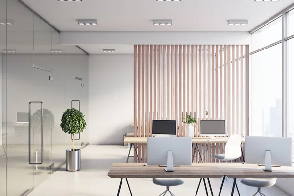 Sunny light spacious office with wooden slatted partition between stylish work places, modern monitors on wooden tables and white floor. 3D rendering