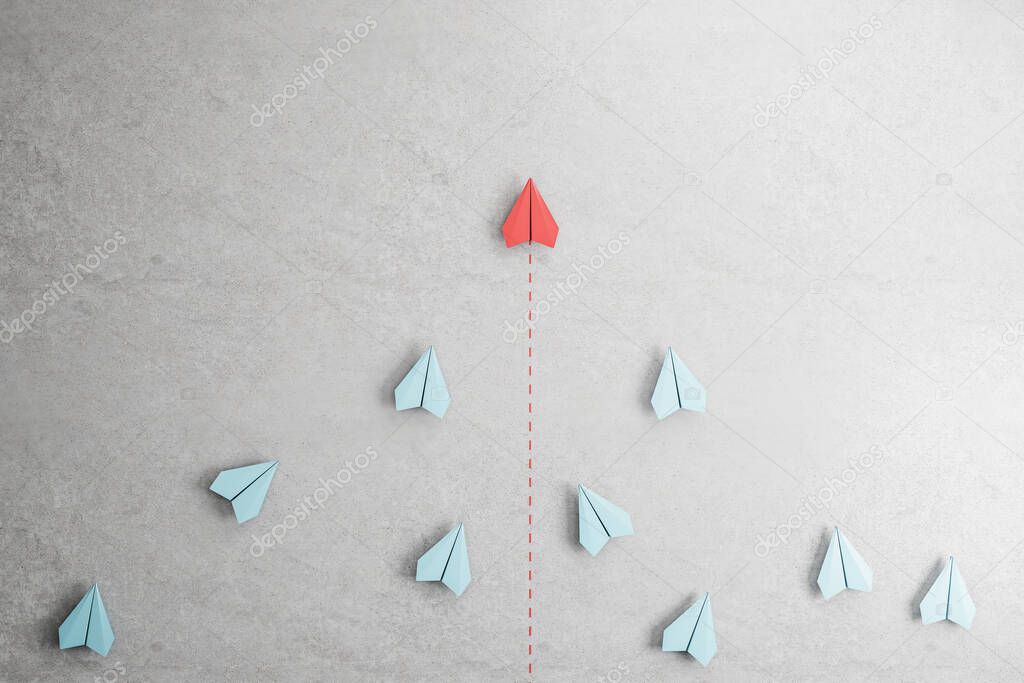 Business success and leadership concept with flying red paper plane at the head of white paper planes on abstract concrete background. 3D rendering