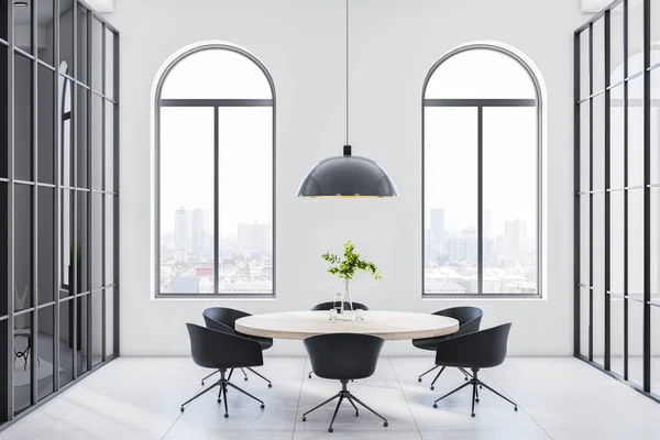 Stylish monochrome style room with light wooden round table and black chairs around on ceramic tales floor, city view from arched windows and modern black vintage lamp from top. 3D rendering