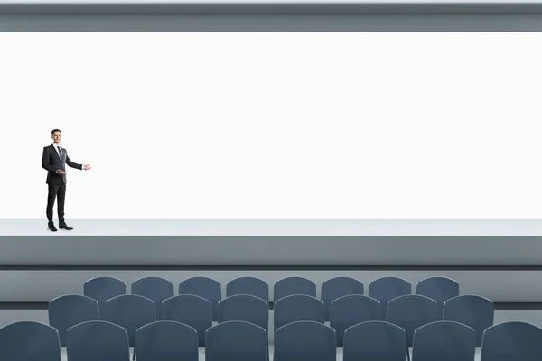 Businessperson Standing Modern Grey Auditorium Seating Empty Screen Mock Place — Stock Photo, Image