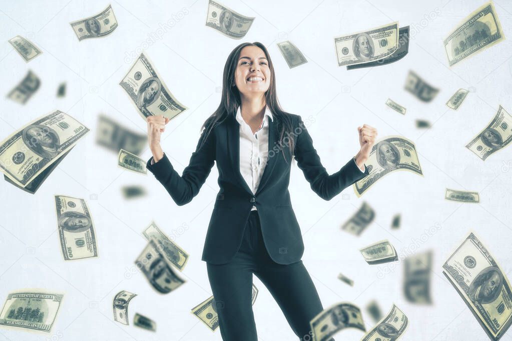 Attractive young european businesswoman celebrating success on white background with dollar banknote rain. Jackpot, wealth and lottery win concept