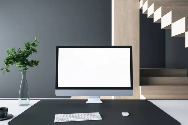 Close up of creative designer desktop with empty white computer monitor frame, decorative items and modern interior in the background. Mock up, 3D Rendering