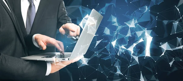 Businessmen hands pointing at laptop with abstract glowing polygonal connections interface on dark background. Web, teamwork and global networking concept. Double exposure