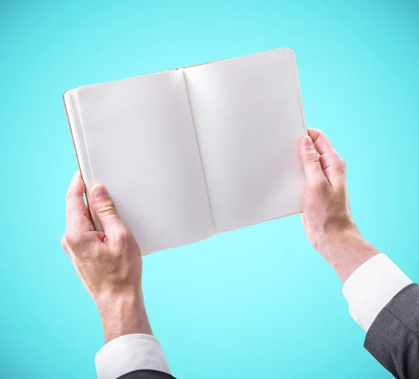 Hands holding a blank book — Stock Photo, Image