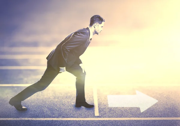 Businessman standing on running track — Stock Photo, Image