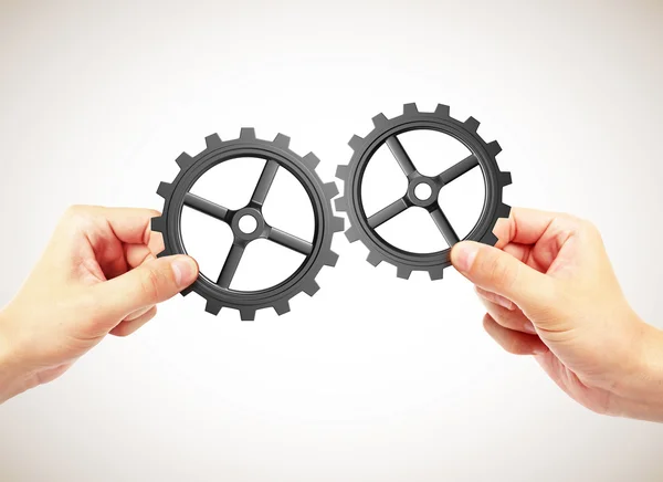 Hands holding gears — Stock Photo, Image