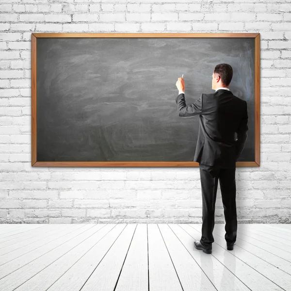 Zakenman tekening op blackboard — Stockfoto