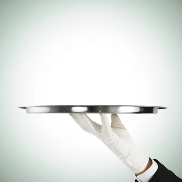 Waiter hand with silver tray — Stock Photo, Image