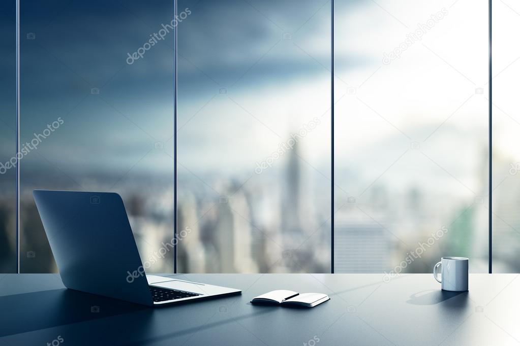 Laptop, cup and diary on table