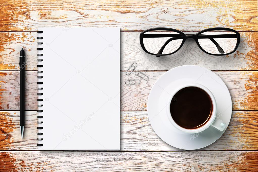 Blank diary, eyeglasses  and coffee cup