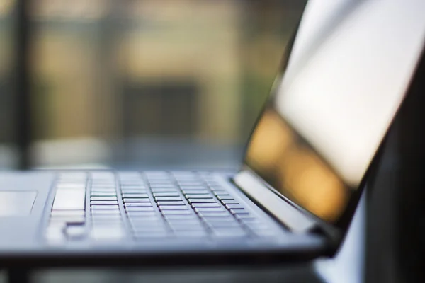 Laptop on table at sunset — Stock Photo, Image