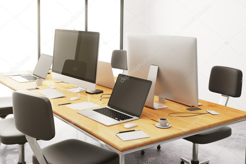 table with office accessories and computers