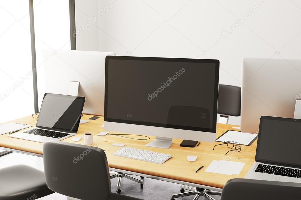 table with office accessories and computers