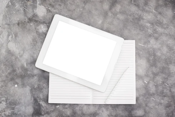 Blank digital tablet and notebook on a concrete background — Stock Photo, Image