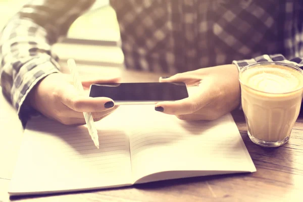 Girl with cell phone, diary and cup of coffee — Stock Photo, Image