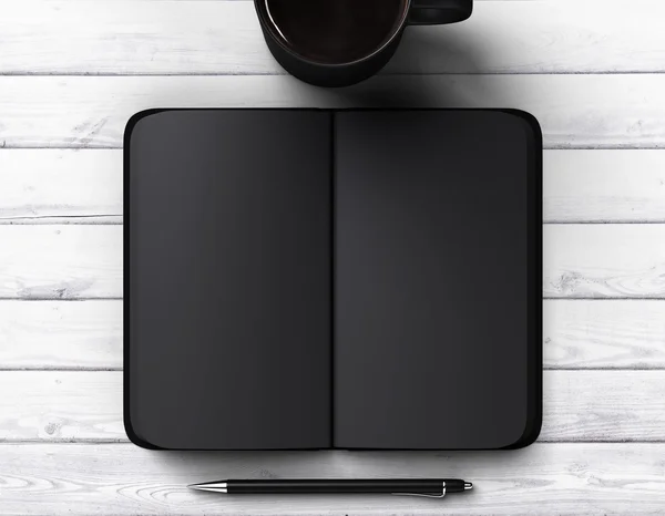 Black blank diary with cup of coffee and pen — Stock Photo, Image