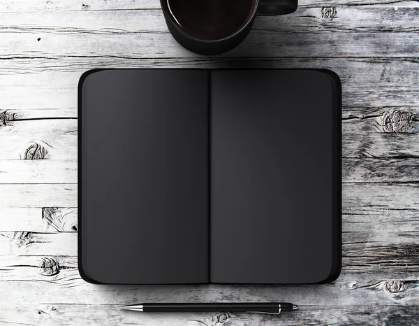 Buku harian hitam kosong dengan pena dan secangkir kopi di atas meja kayu — Stok Foto