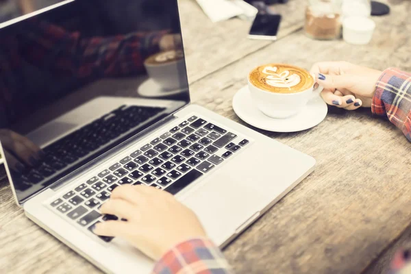 Laptop e uma menina com cappuccino ao ar livre — Fotografia de Stock
