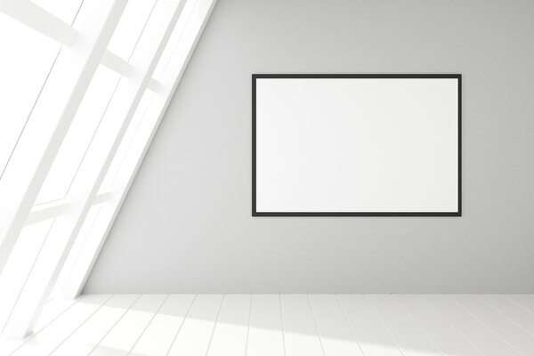 Blank frame on wall in empty white loft interior