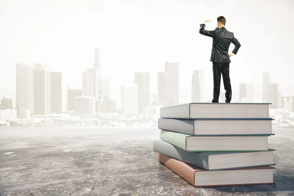 Businessman standing on  stack of books — Stock Photo, Image