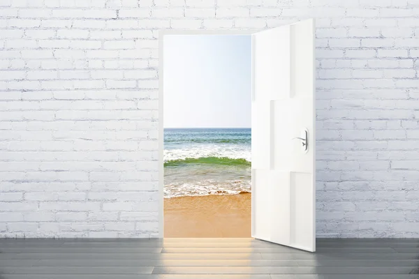 Ocean view concept from the open door of brick room with wood fl — Stock Photo, Image