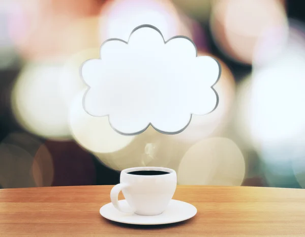 Cup of coffee with speech bubble in the form of cloud on wooden — Stock Photo, Image