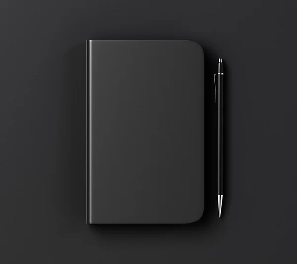 Prázdný obal černý deník a pera na černém stole, vycpat se — Stock fotografie